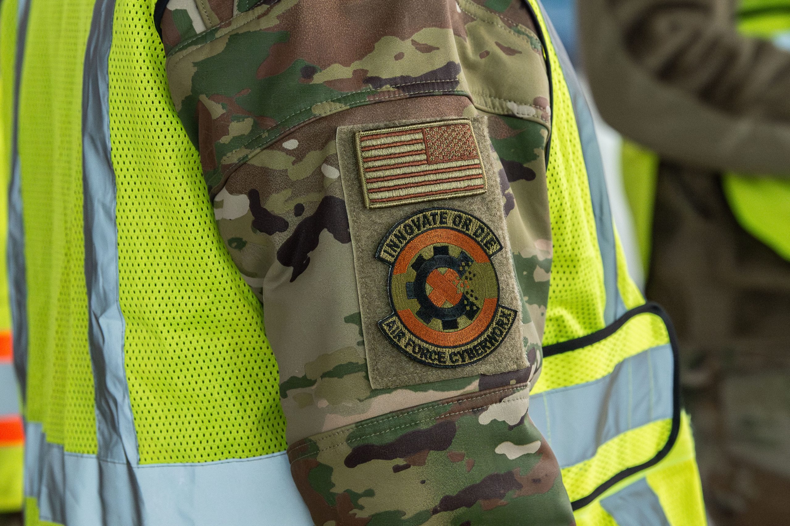 patch on sleeve of American land and one below with words Innovate or Die and Air Force CyberWorx